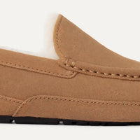Brown loafer shoe on a light gray background