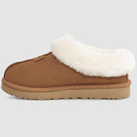 Brown slipper with white fur lining on a light gray background