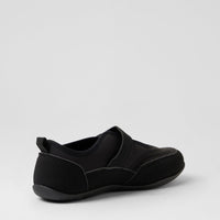 A black slip-on shoe with a wide strap and a pull tab at the heel, shown from a side-rear angle on a light gray background.