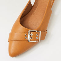 A tan leather pointed-toe flat shoe with a decorative strap across the instep featuring a silver-tone metal buckle, shown on a clean white background.