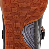Close-up of the sole of a shoe, showing a textured brown rubber tread with a circular 'aetrex' logo in the bottom center.