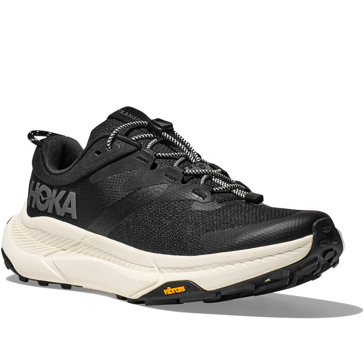 Quarter turn view Women's Hoka Footwear style name Transport in color Black/ Alabaster. Sku: 1123154-BKLB