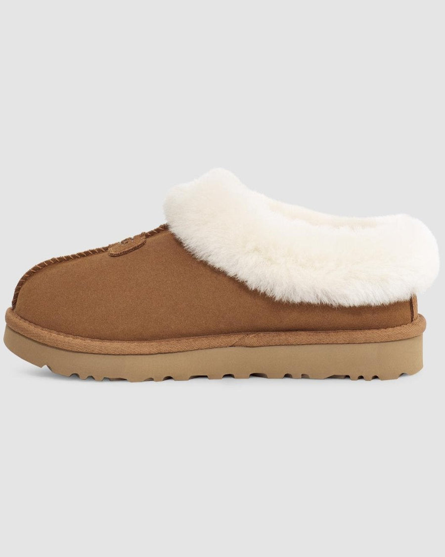 Brown slipper with white fur lining on a light gray background