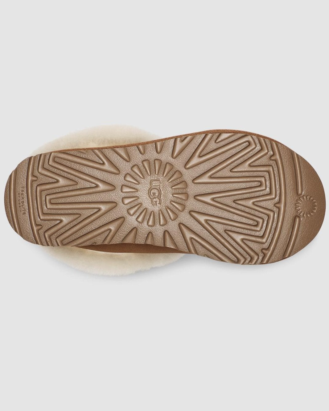 Close-up of a brown sole with a brand logo on a light gray background