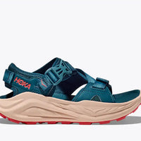 Blue sandal with beige sole and red accents on a white background