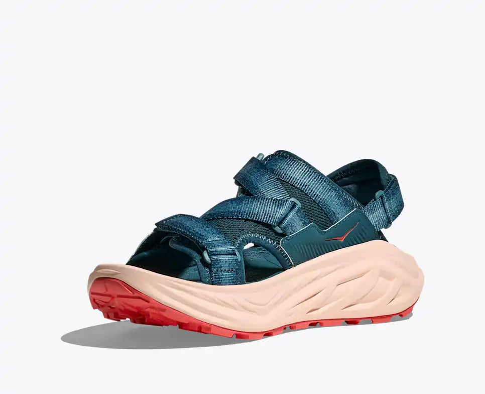 Blue sandal with a red sole on a white background