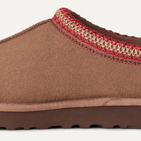 Brown slipper with red and beige trim on a white background