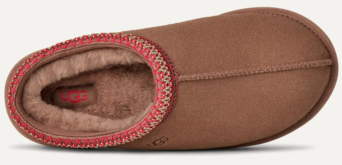 Brown slipper with red interior lining on a white background