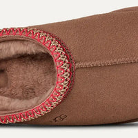 Brown slipper with red interior lining on a white background