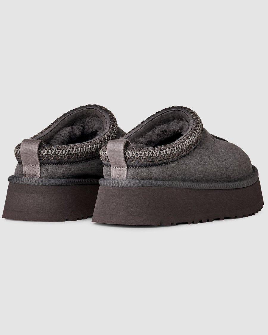 Pair of gray platform sandals on a light gray background