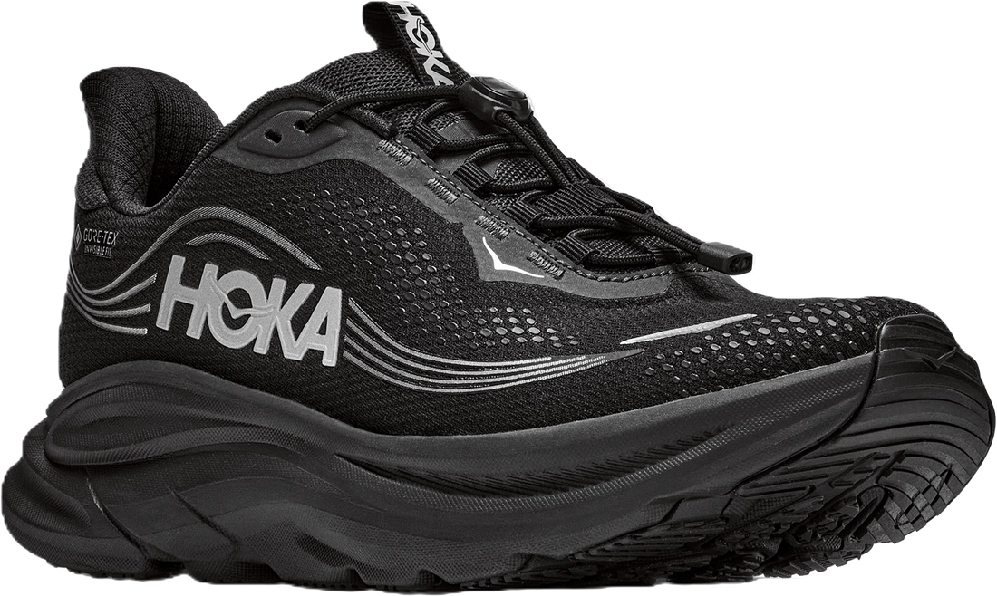 A black Hoka running shoe with a thick black sole, featuring the HOKA logo in white on the side and a small white logo on the toe box, set against a plain white background.