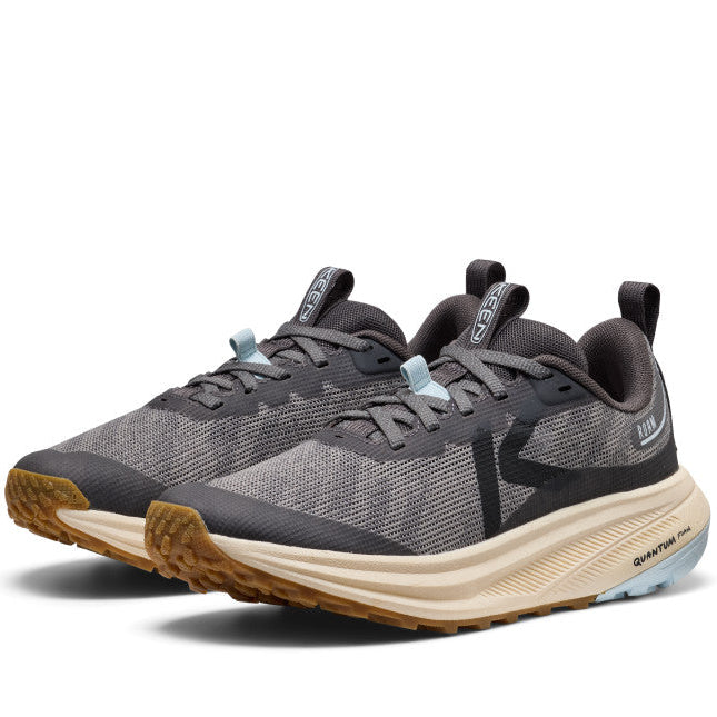 Pair of gray athletic shoes with brown soles on a white background