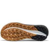 Close-up of a shoe sole with brown tread pattern on a white background