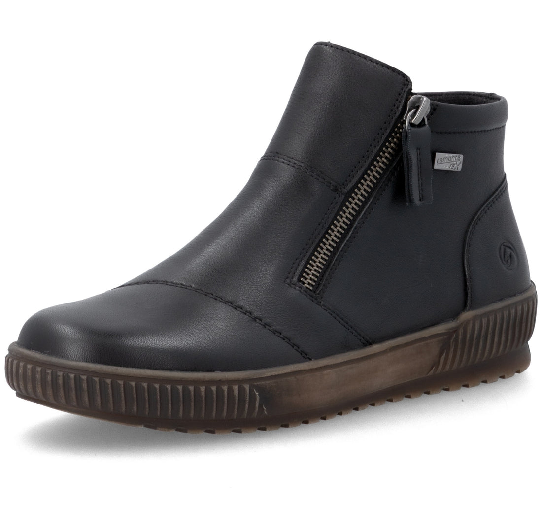 A black leather ankle boot with a side zipper, brown sole, and a small silver metal tag on the side.