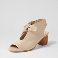 Beige open-toe shoe with wooden heel on a light gray background