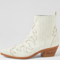 White cowboy boot with brown sole on a light gray background