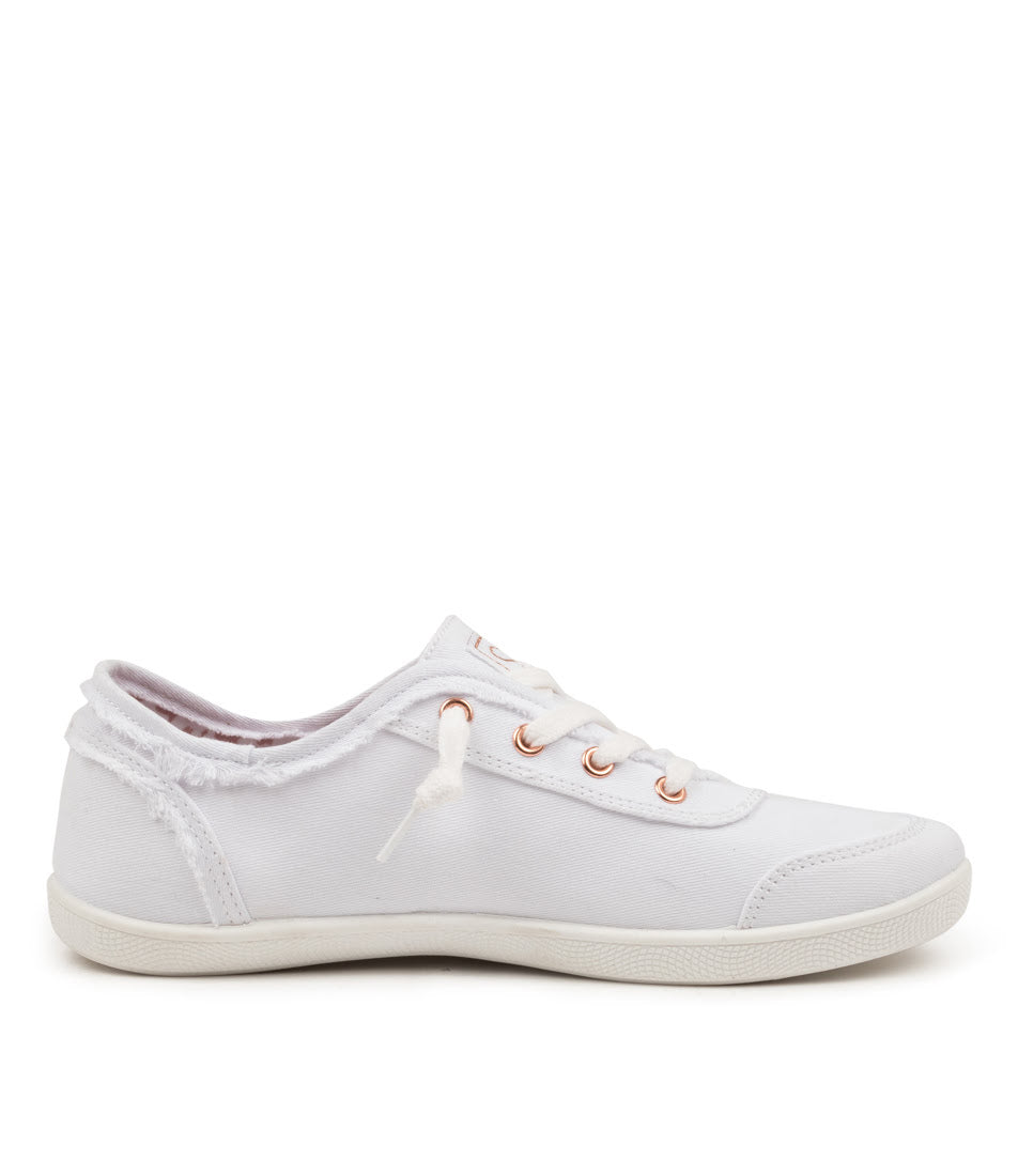 A white low-top canvas sneaker with distressed detailing on the sides, white laces, and rose gold metal eyelets, shown in a side profile on a white background.
