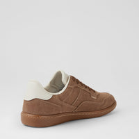 A low-top brown suede sneaker with a cream-colored heel tab and collar lining, shown from a three-quarters angle on a light gray background.