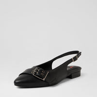 A single black leather slingback flat shoe with a pointed toe and a decorative buckle strap across the vamp, photographed on a light gray studio background.