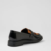 A black patent leather loafer with a brown and black patterned insole, shown from a side-rear angle on a light gray background.