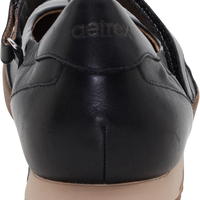 A close-up rear view of a black leather Detro shoe with a tan sole, showing the embossed Detro logo on the heel.
