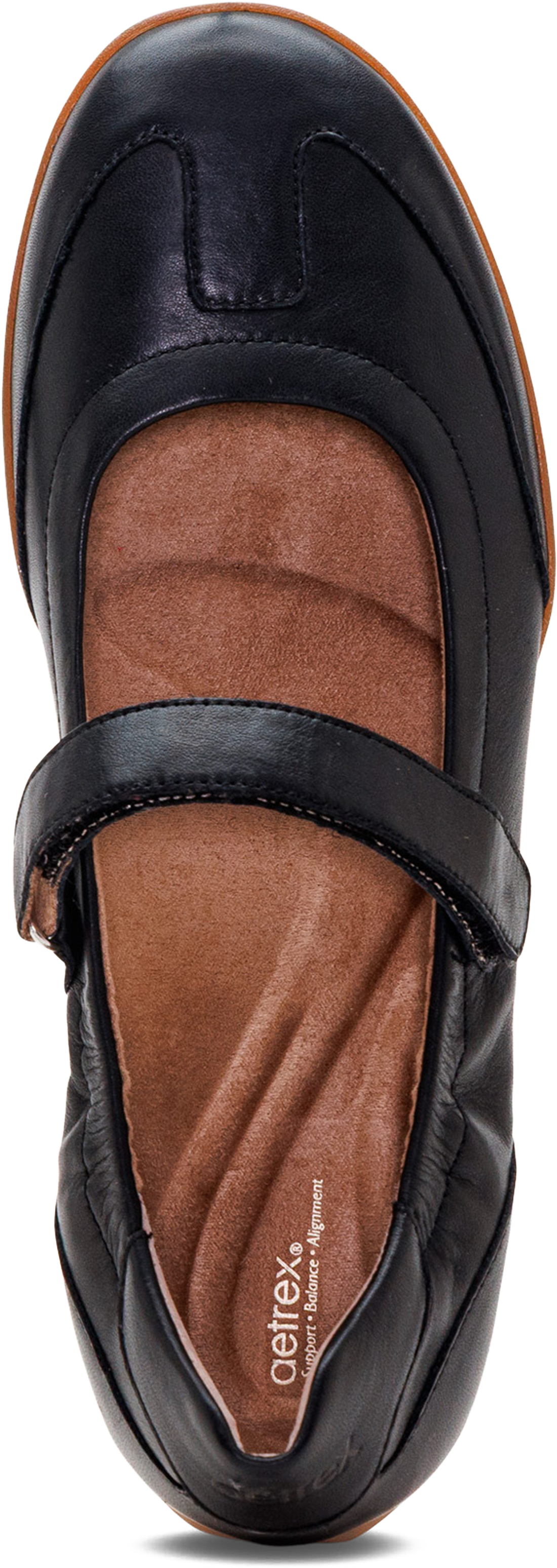 A single black leather Mary Jane shoe shown from a top-down angle, featuring a brown contoured insole and a hook-and-loop strap closure. The brand name &