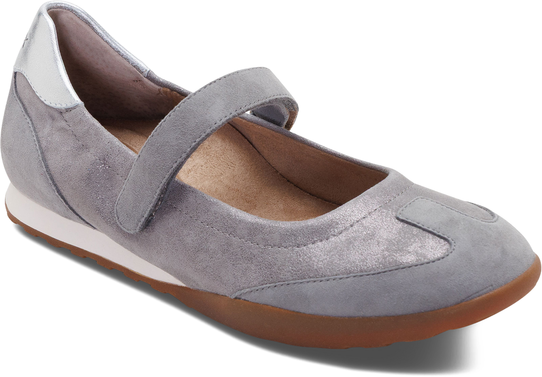 A light gray suede Mary Jane flat shoe with a brown gum sole, shown from a three-quarters angle on a white background.