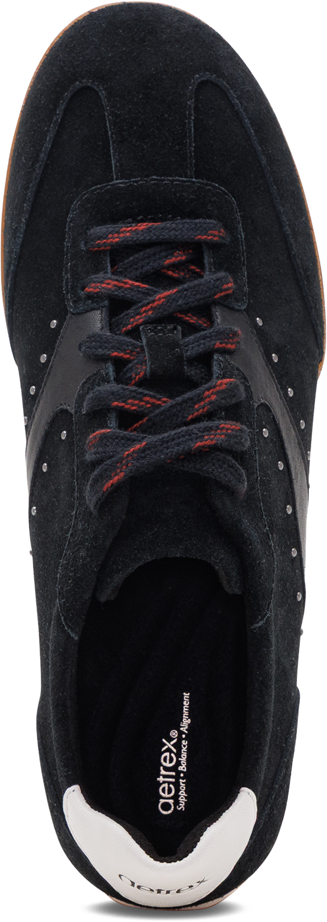 A close-up top-down view of a black suede sneaker with red laces and a white heel tab, showing the &