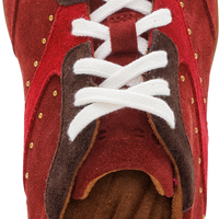 A close-up top-down view of a red and brown sneaker with white laces, showing the textured red suede upper, brown leather overlays, and a brown GelTex cushioned insole.