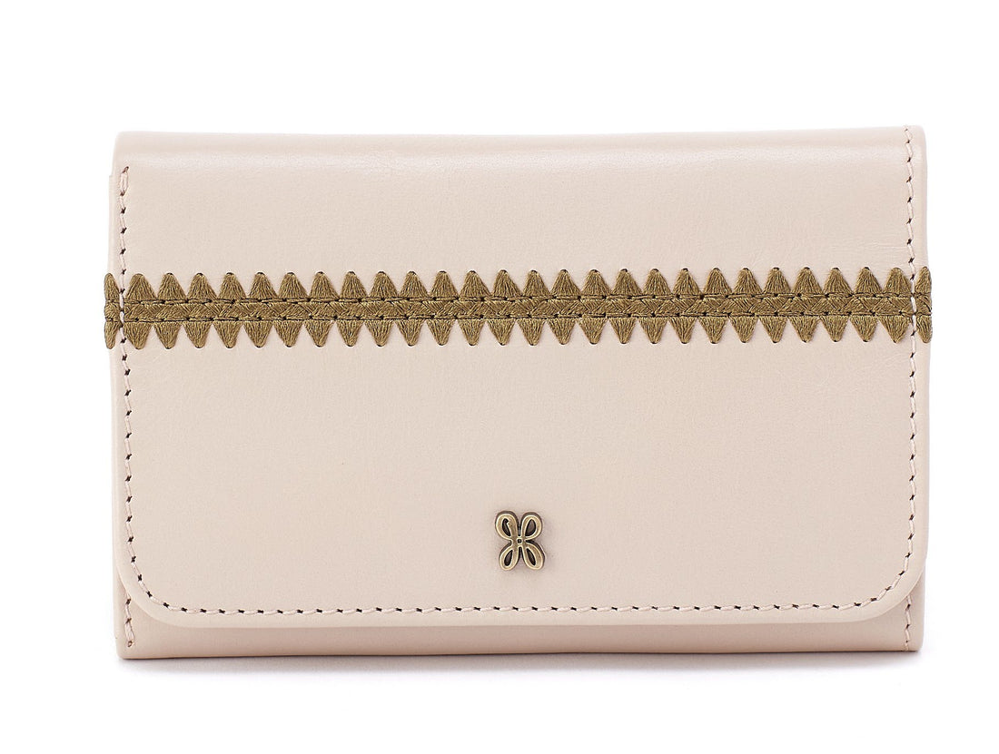 Beige wallet with decorative stitching on a white background