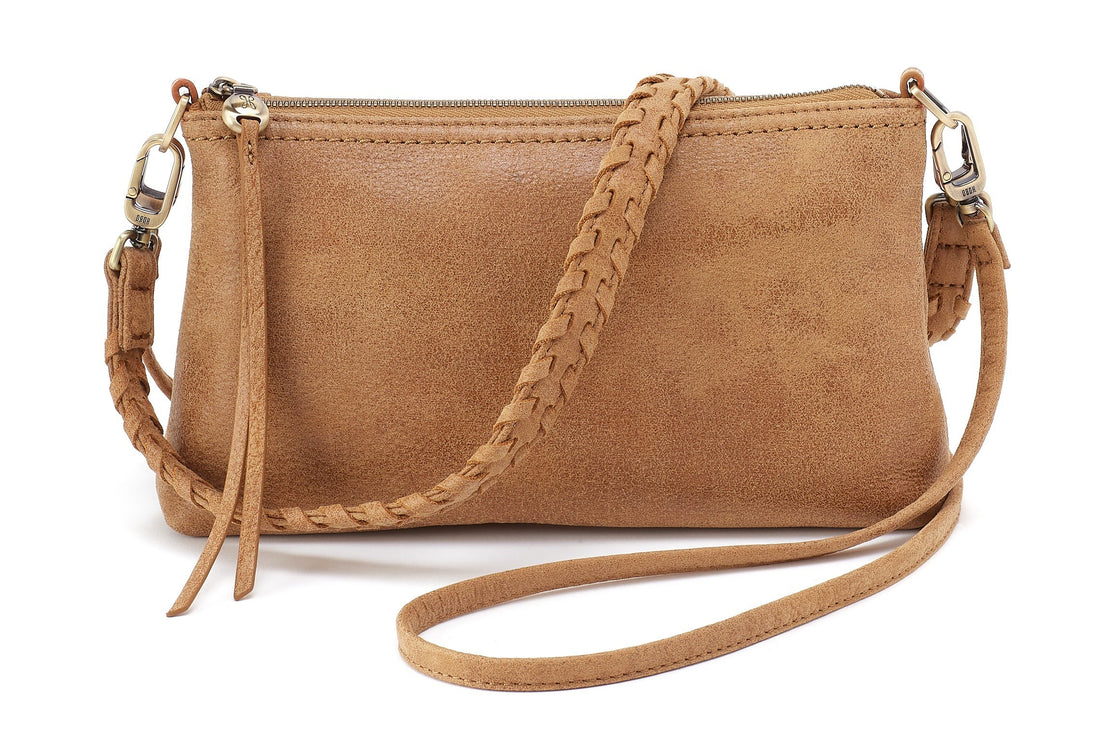 Brown leather crossbody bag with braided strap on a white background