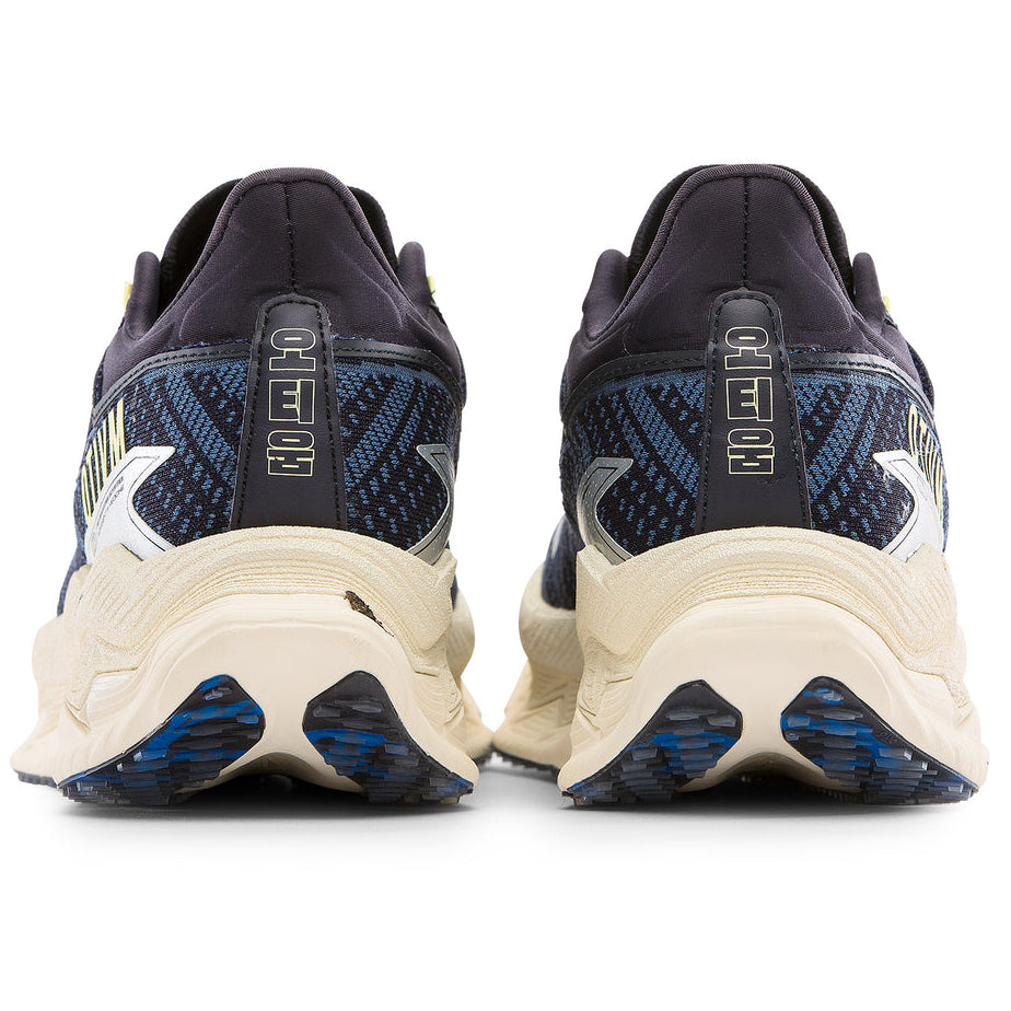 Pair of running shoes showing the sole design on a white background