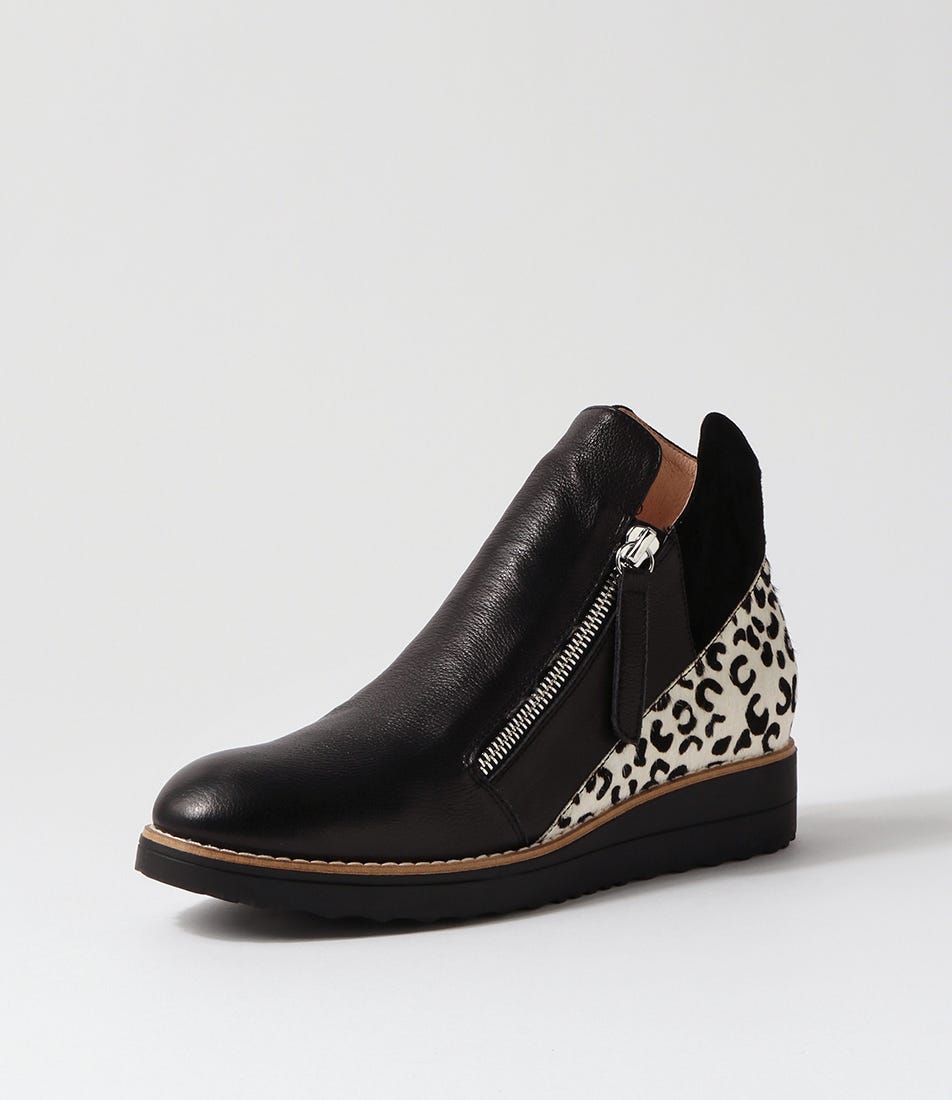 Black wedge shoe with leopard print heel on a light gray background