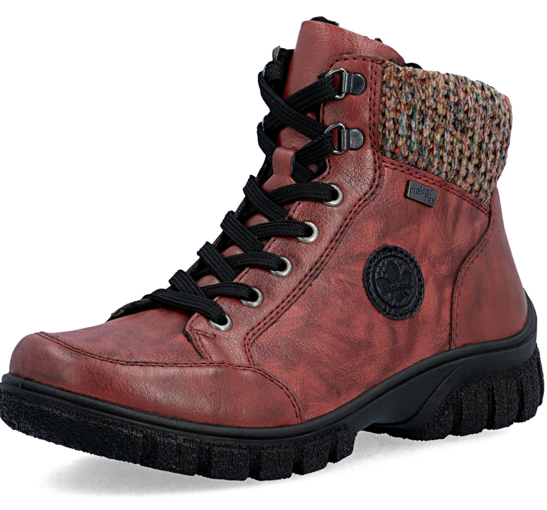 A single mid-calf lace-up boot in distressed reddish-brown leather with black laces, a black rugged sole, and a multicolor knit collar, shown on a white background.